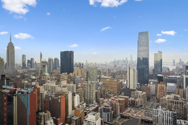 a bedroom with a bed and a potted plant