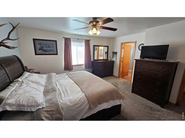 a bedroom with a bed and a television