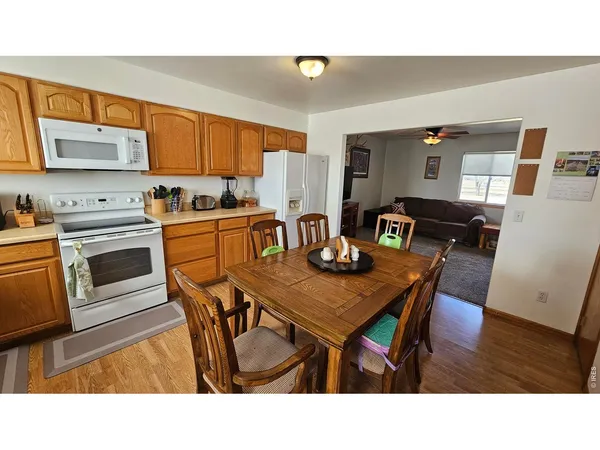 a kitchen with stainless steel appliances kitchen island a table and chairs in it