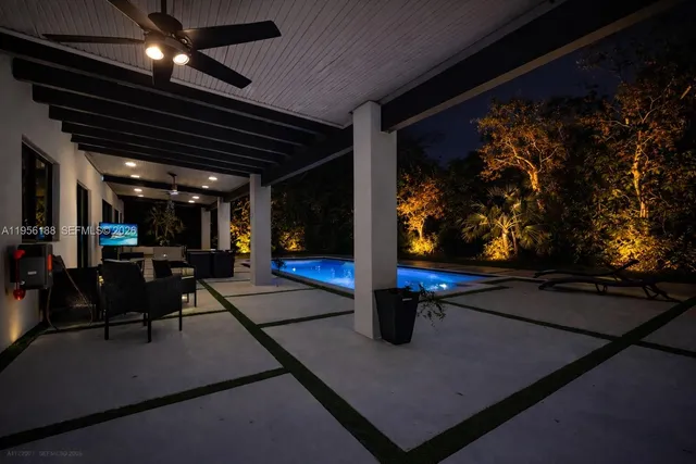 a view of a porch with a table and chairs