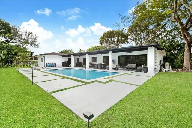 a view of house with a backyard porch and sitting area