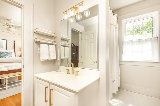 a bathroom with a sink a mirror and a shower