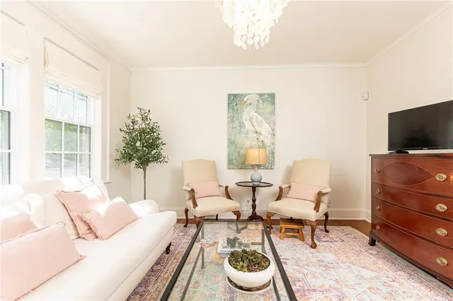a living room with furniture and a flat screen tv