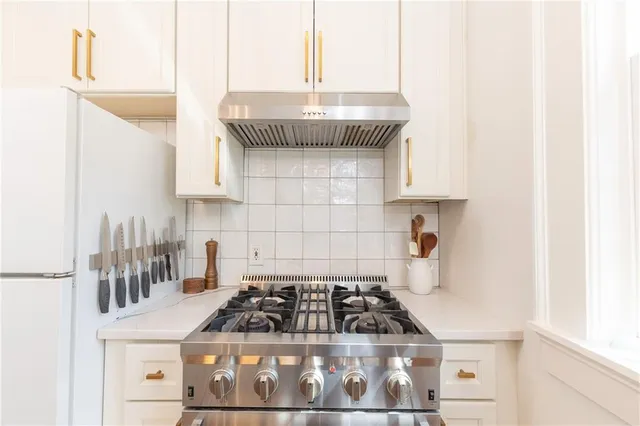 a kitchen with granite countertop a stove and a sink