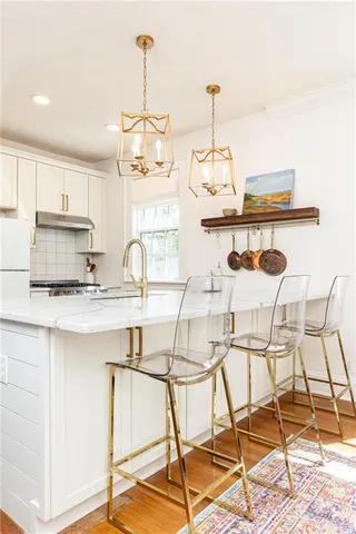a kitchen with a table and chairs in it