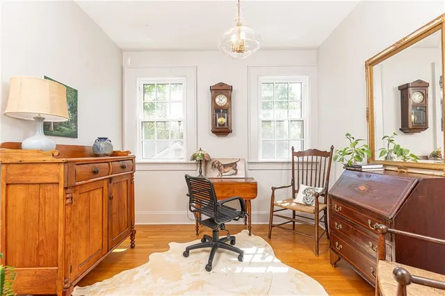 a view of a workspace with furniture and a window