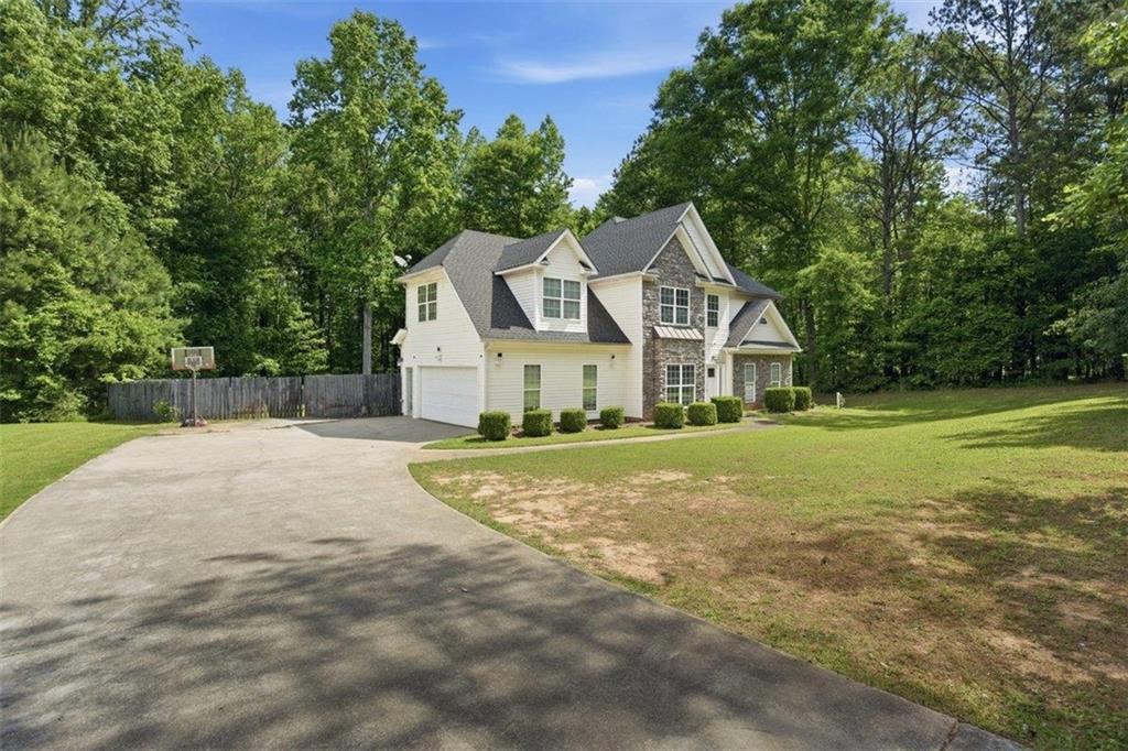 1231 Hillview Road Hampton, GA 30228 - Photo 32 of 49 a view of a house with a big yard and large trees