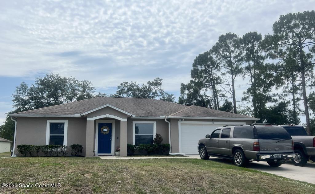 350 Wendover Road Southwest Palm Bay, FL 32908 - Photo 1 of 1 a front view of a house with a garden