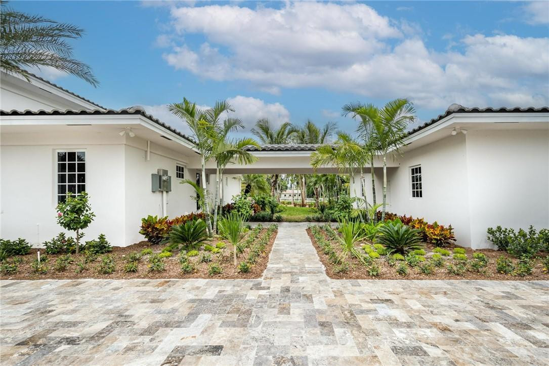 13731 Stirling Road Southwest Ranches, FL 33330 - Photo 11 of 55 a front view of a house with garden