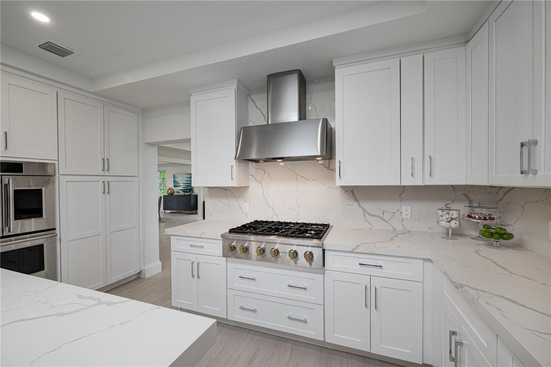 13731 Stirling Road Southwest Ranches, FL 33330 - Photo 27 of 55 a kitchen with white cabinets and white appliances