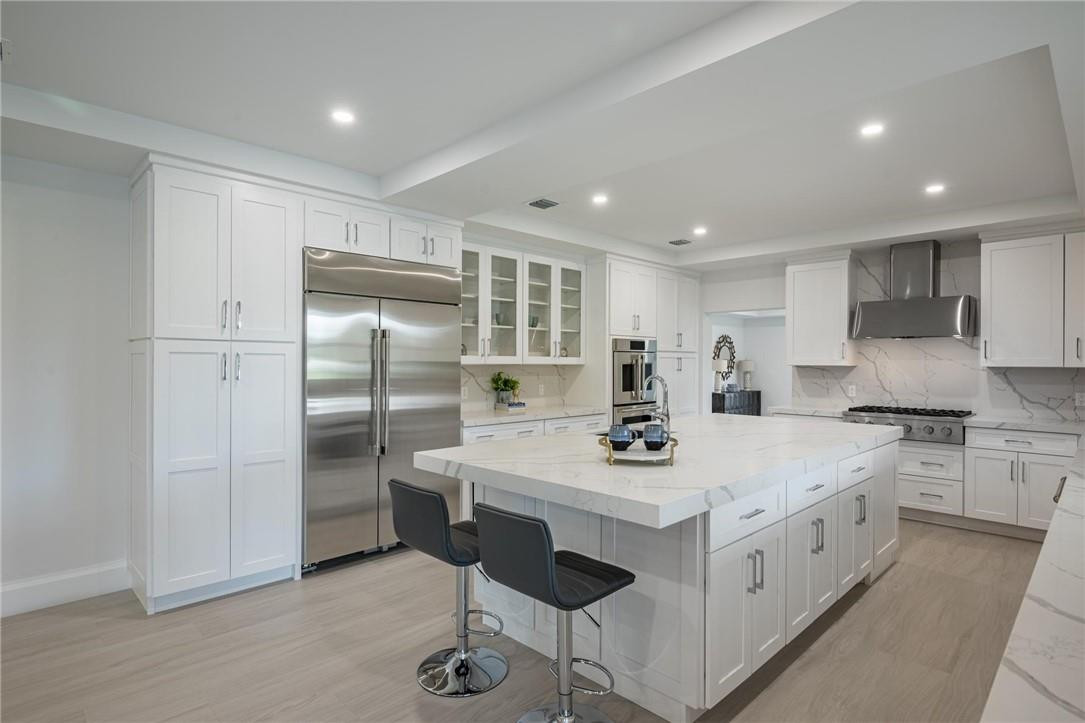 13731 Stirling Road Southwest Ranches, FL 33330 - Photo 29 of 55 a kitchen that has a sink a stove and chairs