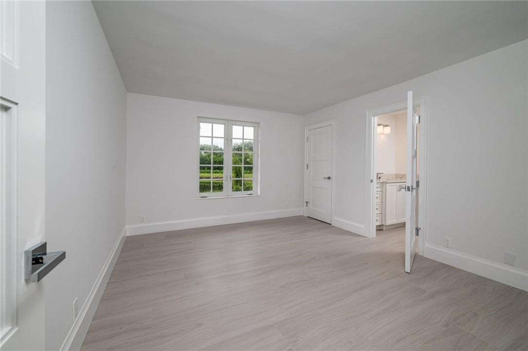 13731 Stirling Road Southwest Ranches, FL 33330 - Photo 36 of 55 an empty room with wooden floor and windows