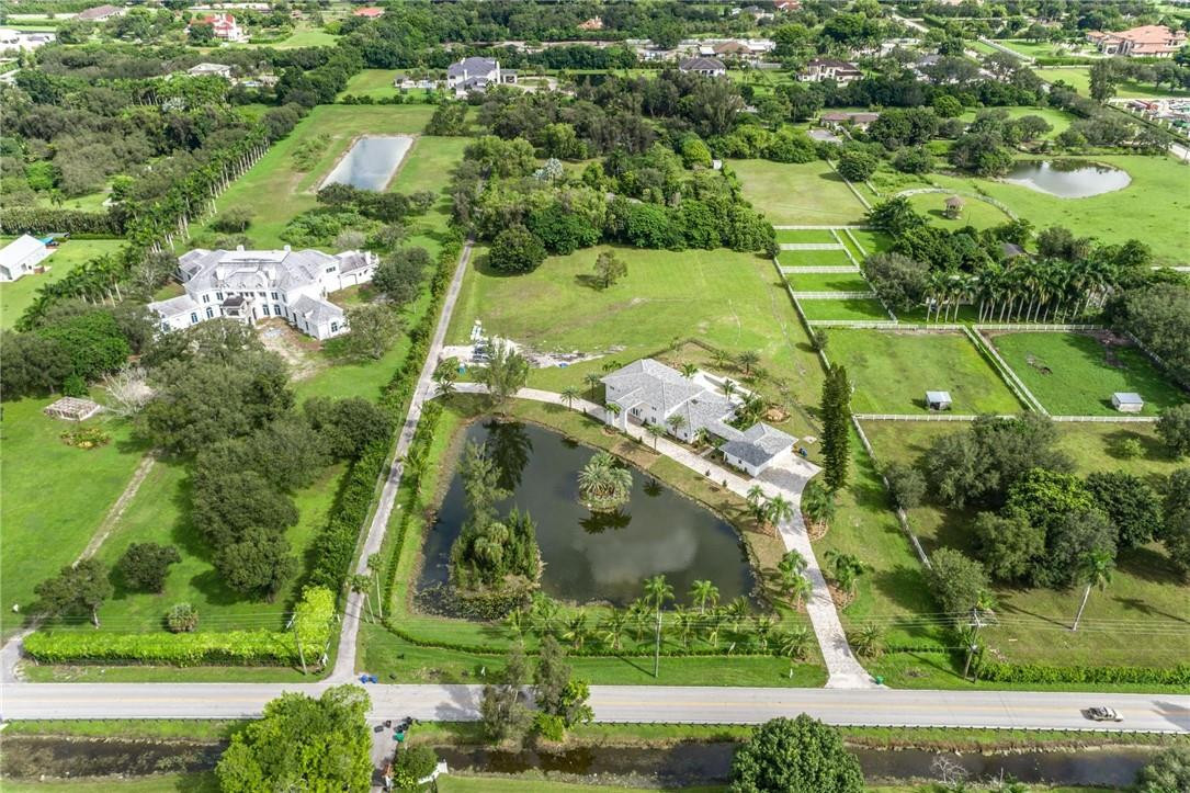 13731 Stirling Road Southwest Ranches, FL 33330 - Photo 4 of 55 an aerial view of a residential houses with yard and swimming pool