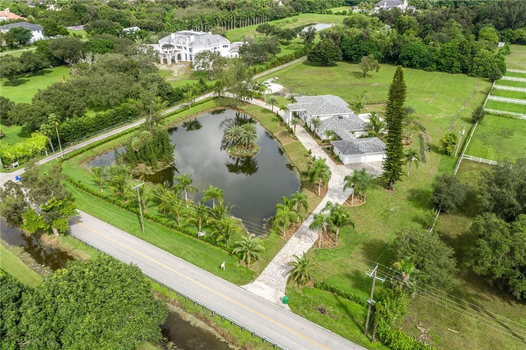 13731 Stirling Road Southwest Ranches, FL 33330 - Photo 5 of 55 a view of a lake with a yard