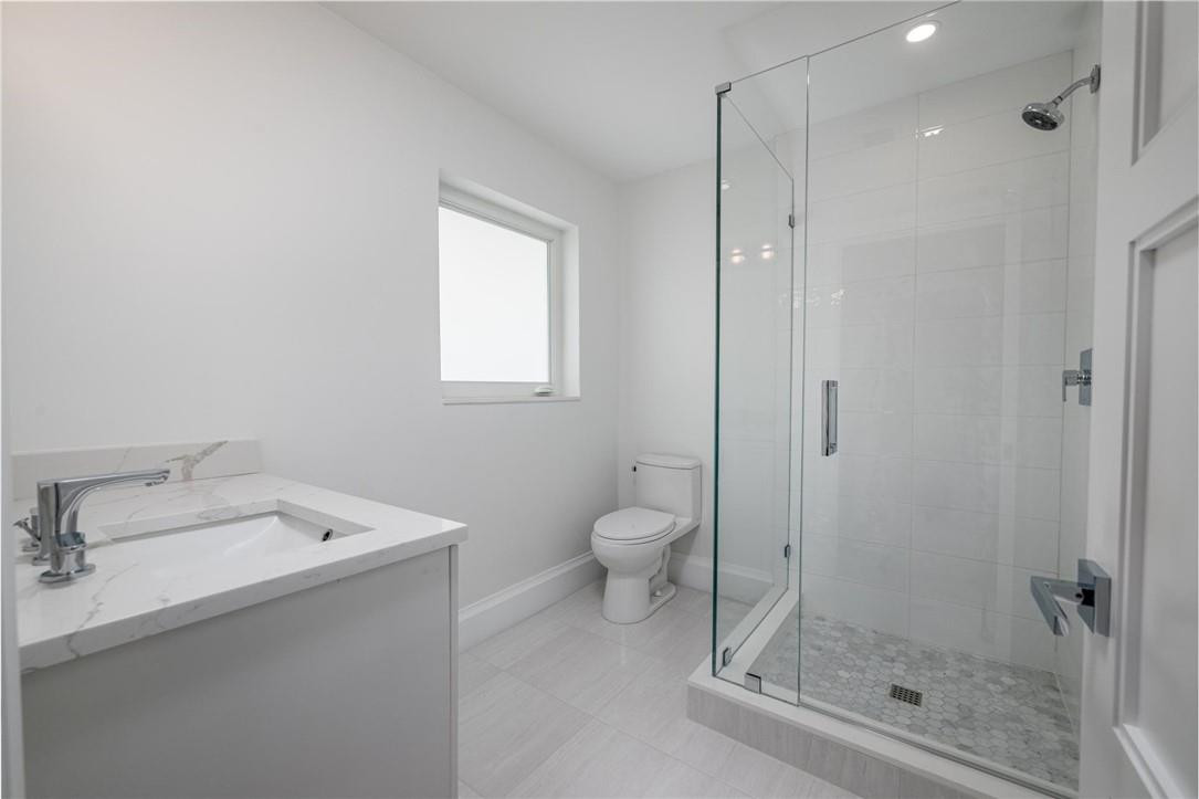 13731 Stirling Road Southwest Ranches, FL 33330 - Photo 52 of 55 a bathroom with a granite countertop sink a mirror and a shower