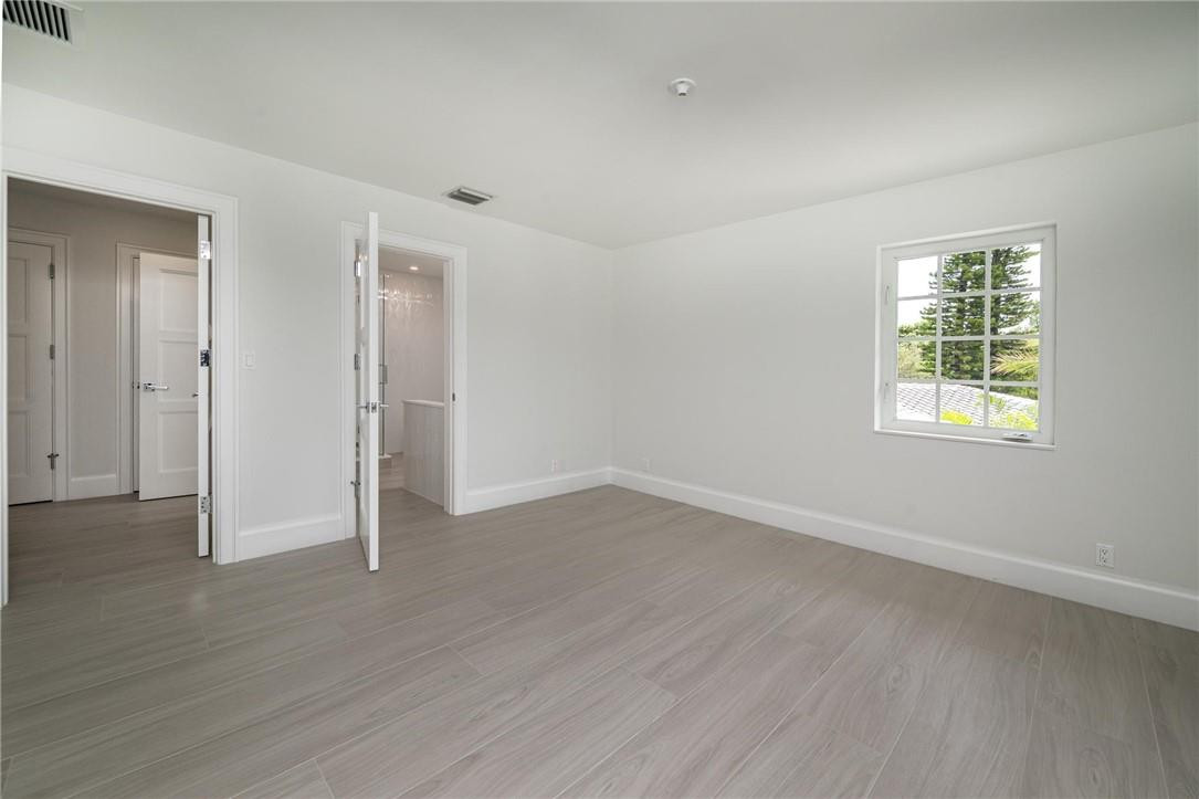 13731 Stirling Road Southwest Ranches, FL 33330 - Photo 53 of 55 an empty room with wooden floor and windows