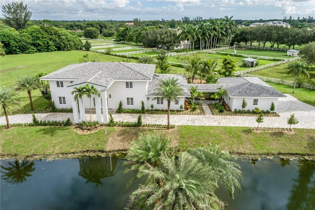 13731 Stirling Road Southwest Ranches, FL 33330 - Photo 7 of 55 a view of an house with backyard and pool