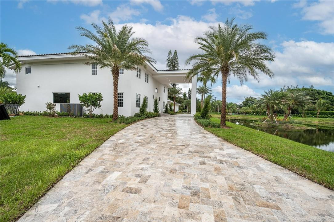 13731 Stirling Road Southwest Ranches, FL 33330 - Photo 10 of 55 a front view of house with yard and green space