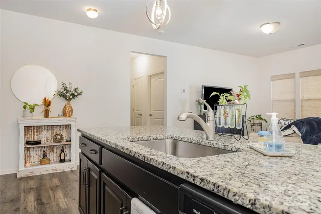 a kitchen with sink and a mirror