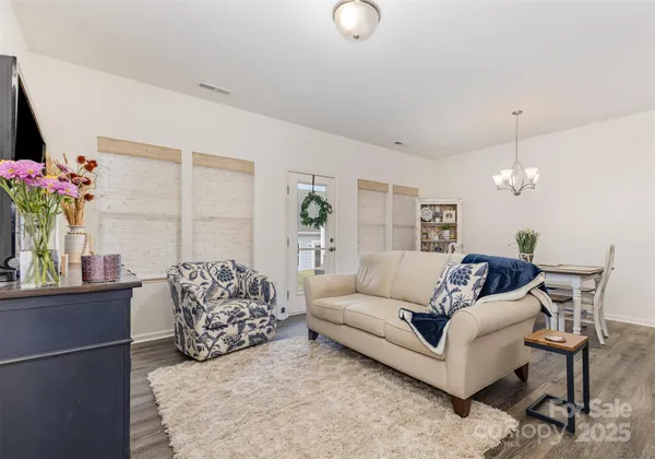 a living room with furniture and flowers