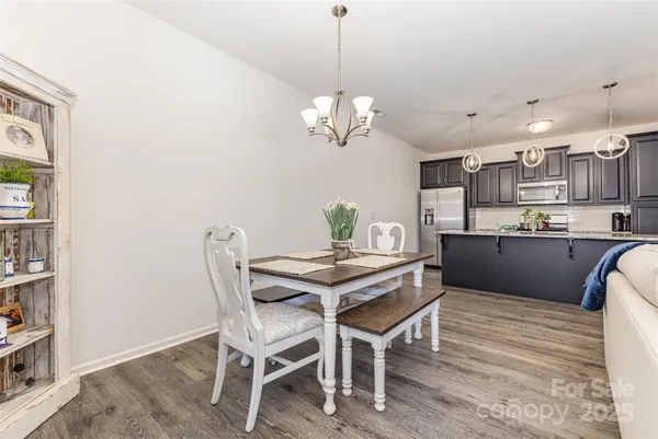 a view of a dining room with furniture wooden floor and chandelier