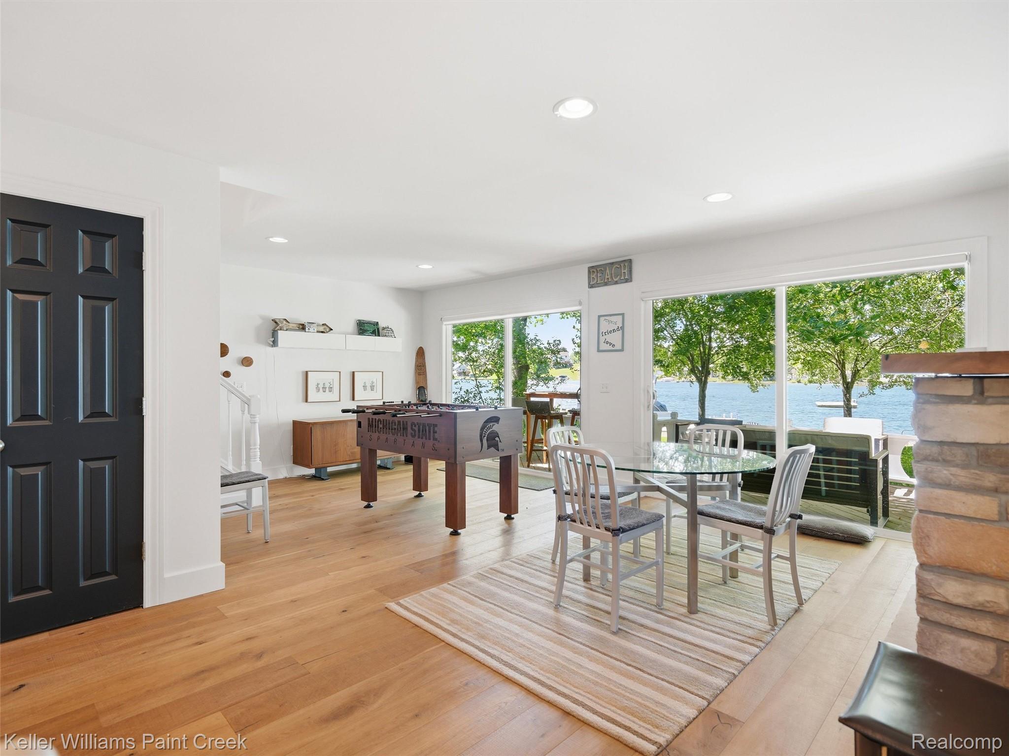 10435 Spring Street Fenton, MI 48430 - Photo 18 of 40 Open-concept living area featuring wood-finish flooring, recessed lighting, and expansive sliding glass doors