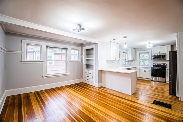 a kitchen with stainless steel appliances granite countertop a refrigerator and a sink