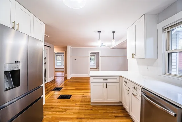 a kitchen with stainless steel appliances granite countertop a refrigerator and a sink