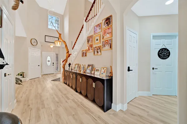 a view of a hallway with wooden floor and staircase