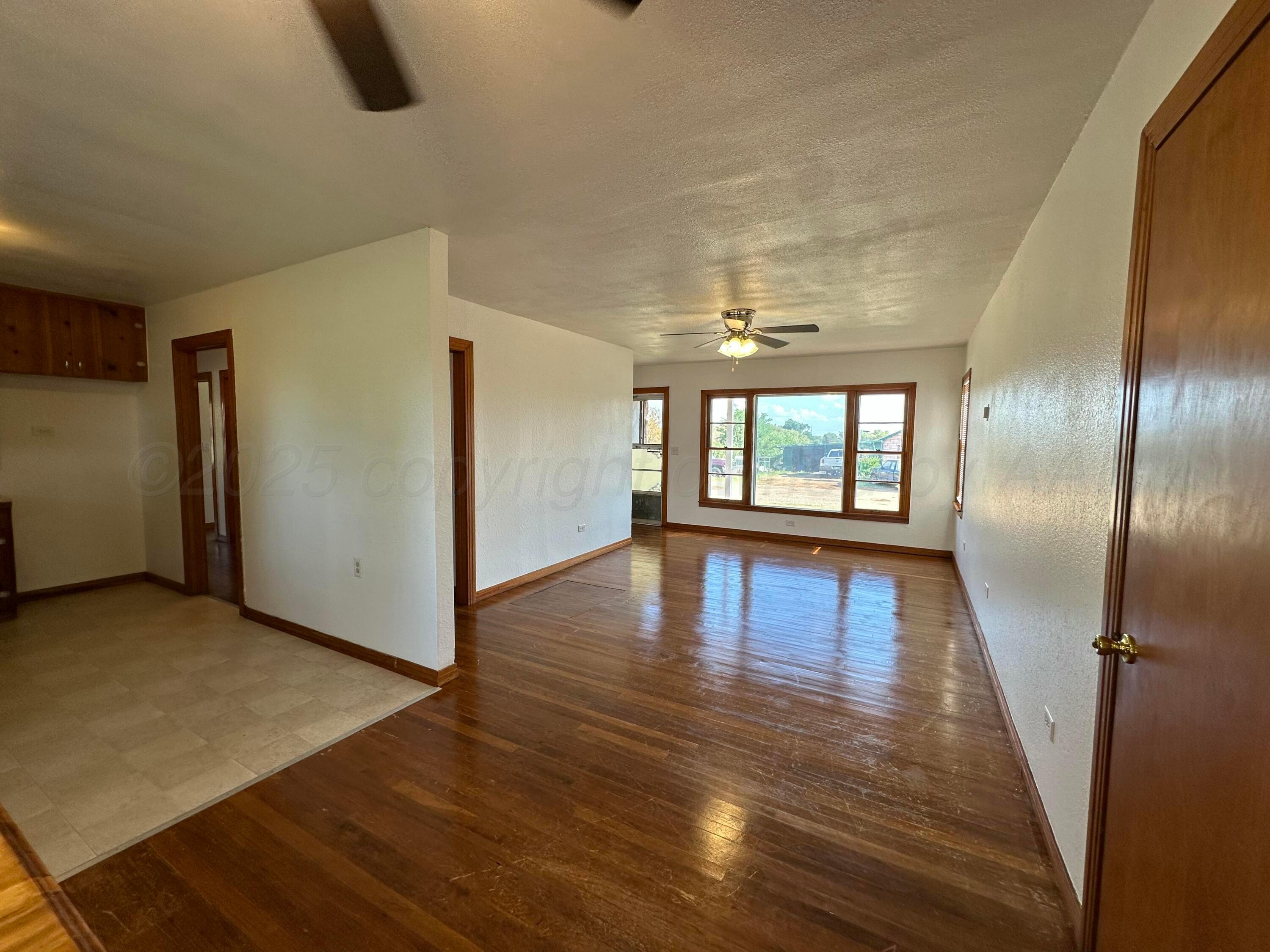 913 Bell Avenue Turkey, TX 79261 - Photo 5 of 18 a view of empty room with wooden floor