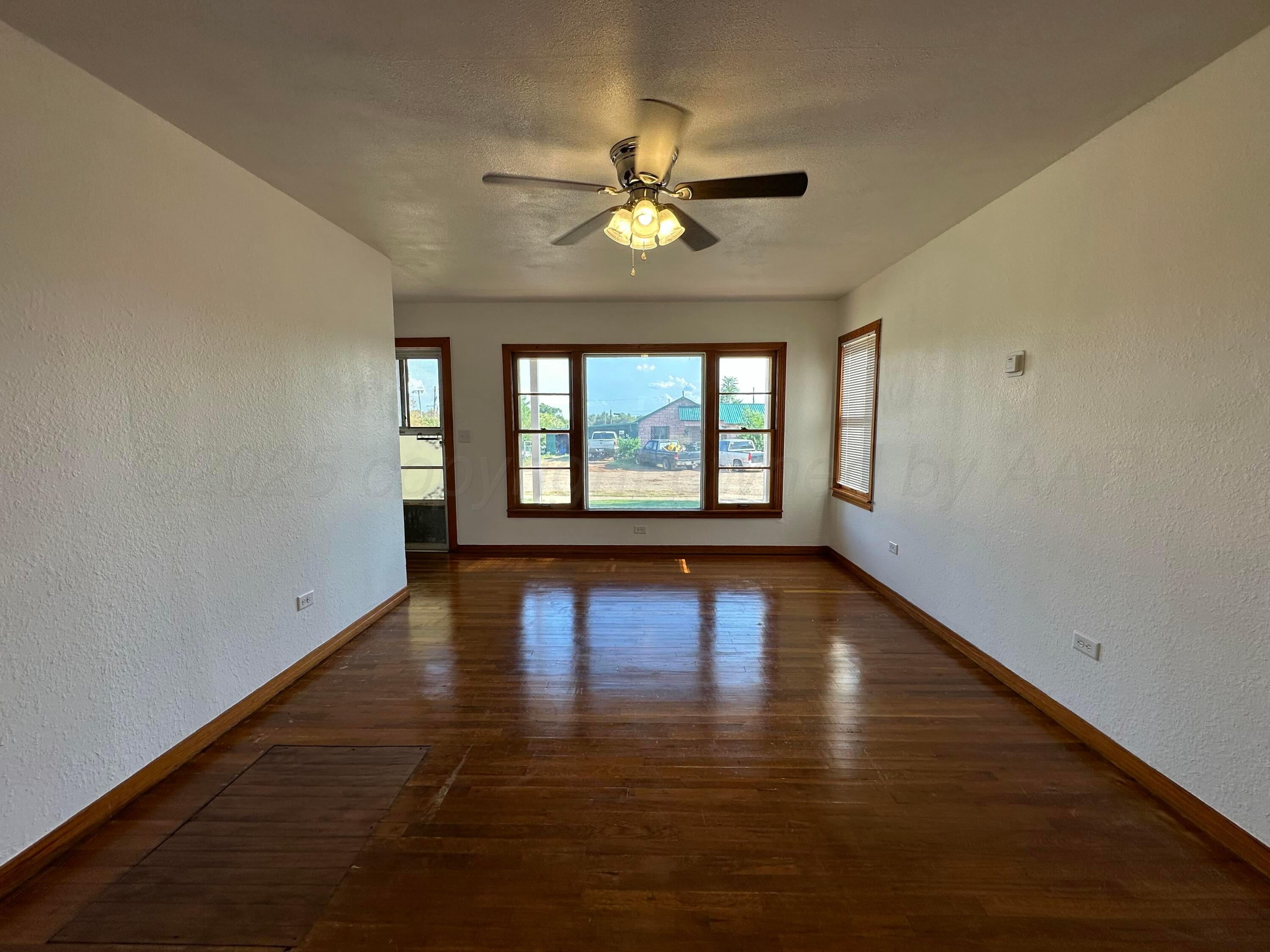 913 Bell Avenue Turkey, TX 79261 - Photo 6 of 18 a view of empty room with wooden floor and fan