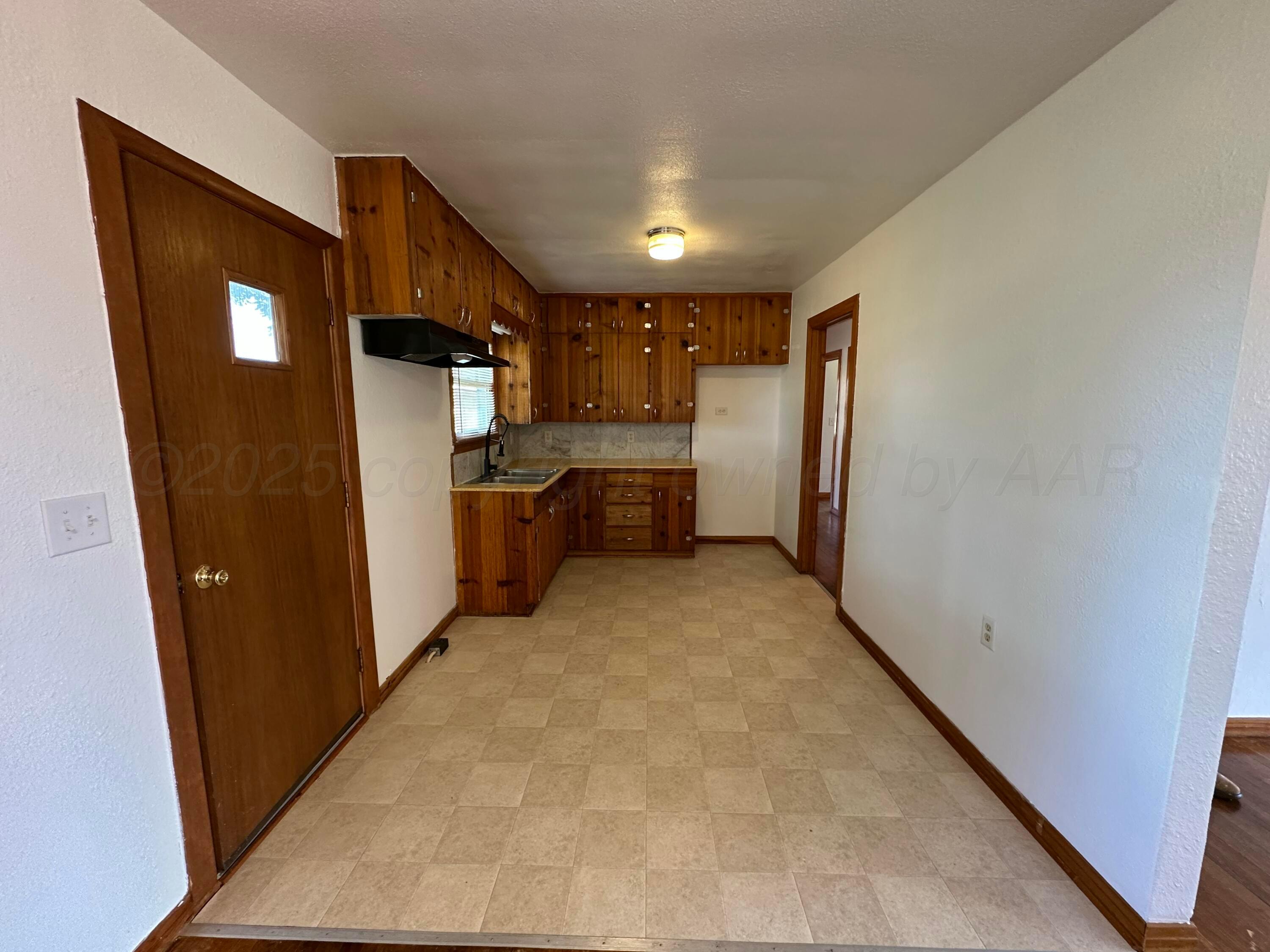 913 Bell Avenue Turkey, TX 79261 - Photo 7 of 18 a view of a refrigerator in kitchen and wooden floor
