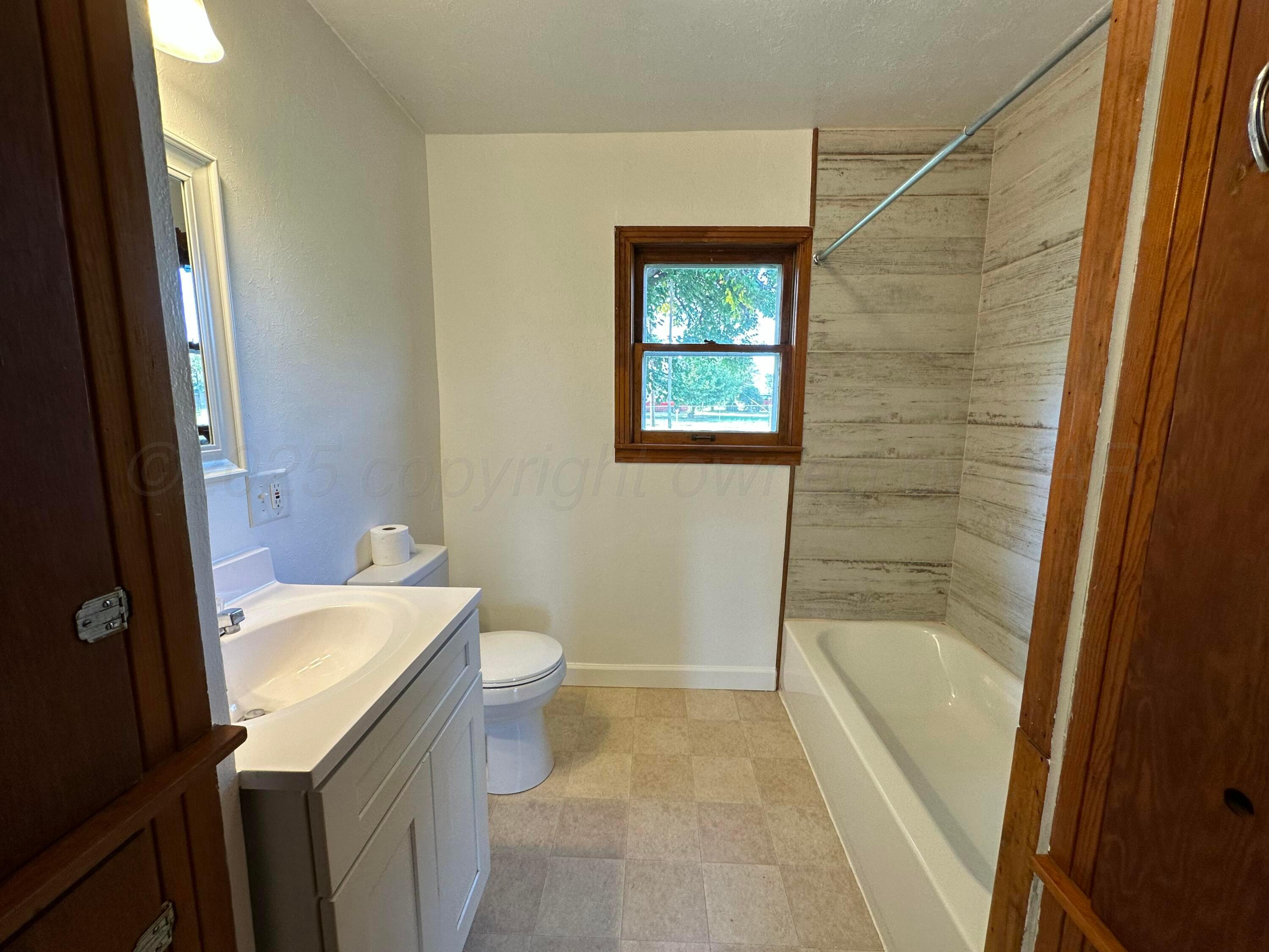 913 Bell Avenue Turkey, TX 79261 - Photo 10 of 18 a bathroom with a sink a toilet and shower