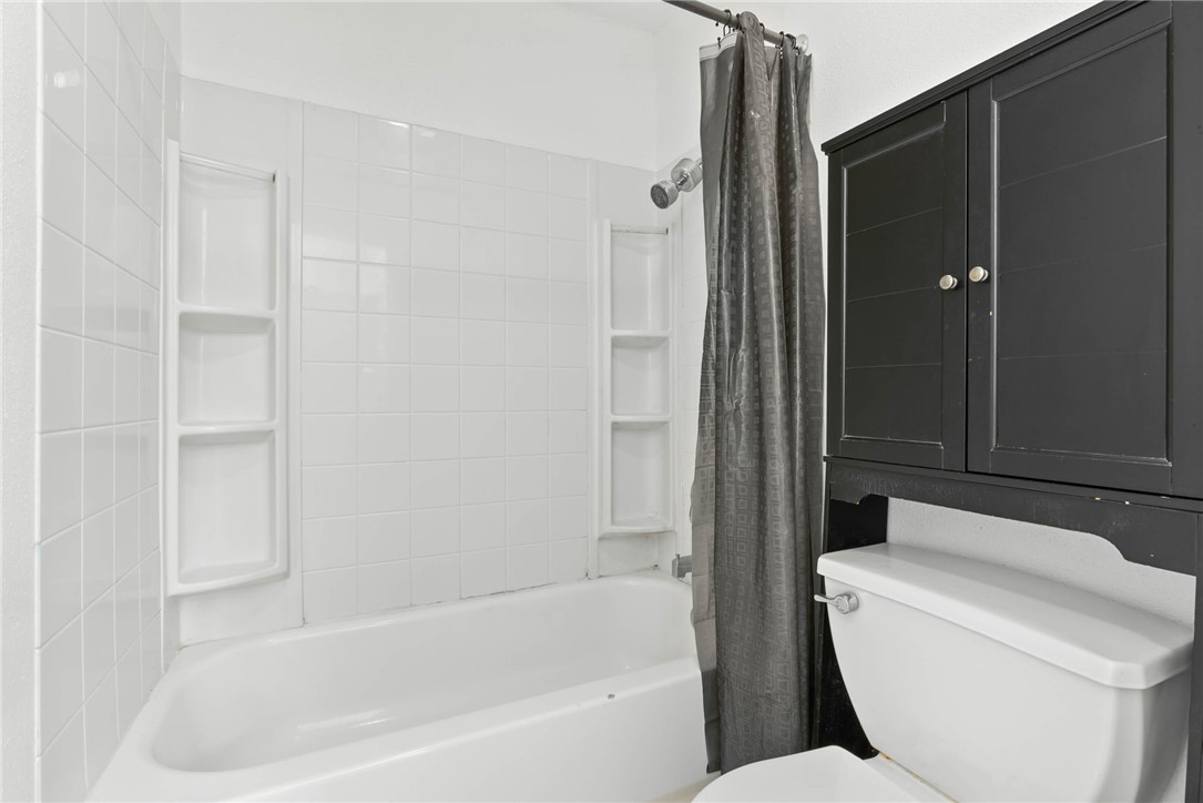 6702 Everhart Road, Unit H102 Corpus Christi, TX 78413 - Photo 11 of 15 a bathroom with a toilet and bathtub