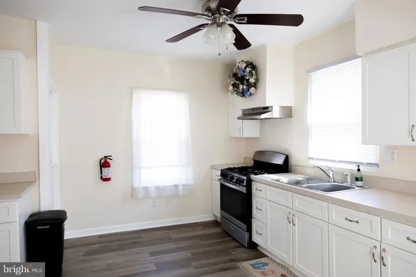 a kitchen with a refrigerator and window
