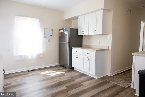 a view of a kitchen with white cabinets