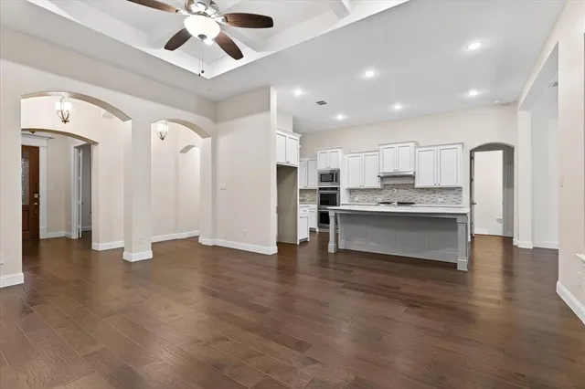 a view of kitchen with refrigerator stove and a ceiling fan