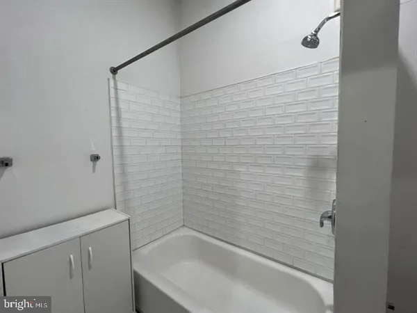 a bathroom with a shower and a sink