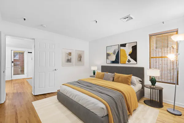 a bedroom with a bed and a painting on the wall