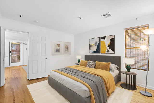 a bedroom with a bed and a painting on the wall