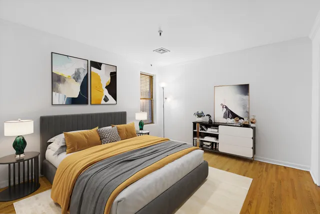 a bedroom with a bed and wooden floor