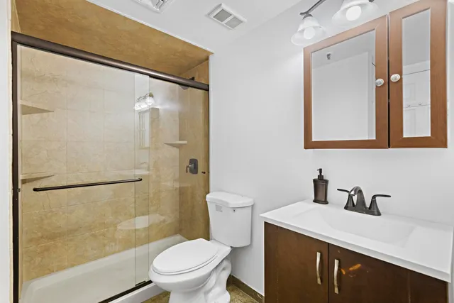 a bathroom with a sink toilet and shower