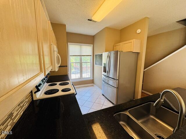 2027 Turtle Point Drive Raleigh, NC 27604 - Photo 5 of 18 a kitchen with a refrigerator and a sink