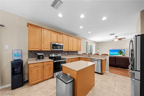 a kitchen with a sink a stove top oven a counter space and cabinets