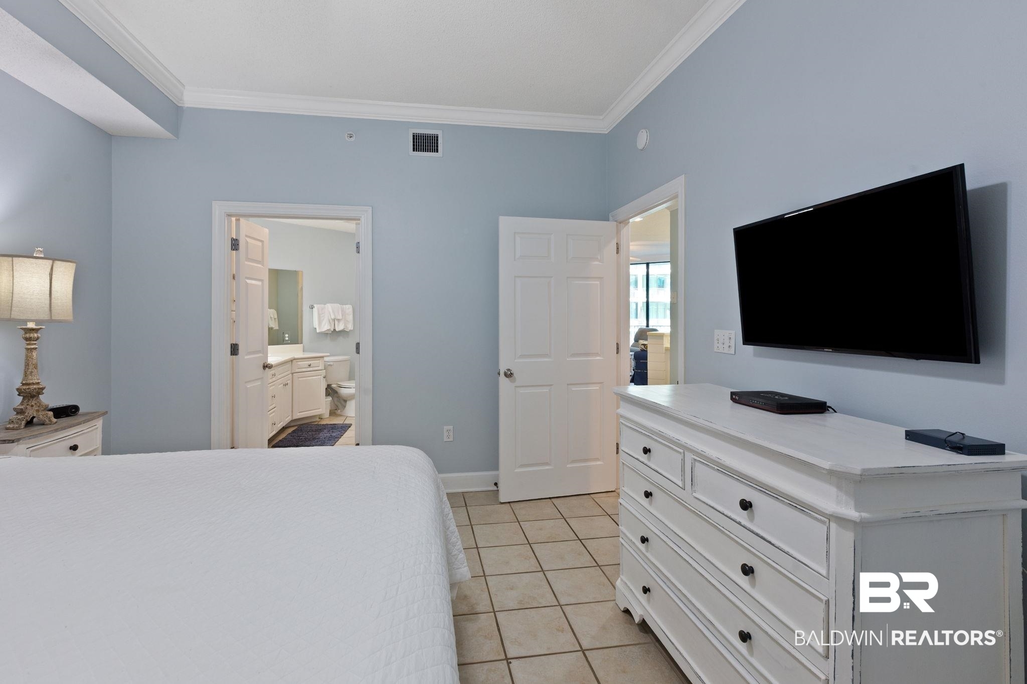 27580 Canal Road, Unit 1112 Orange Beach, AL 36561 - Photo 20 of 50 Bedroom with light tile patterned floors, ornamental molding, and ensuite bath