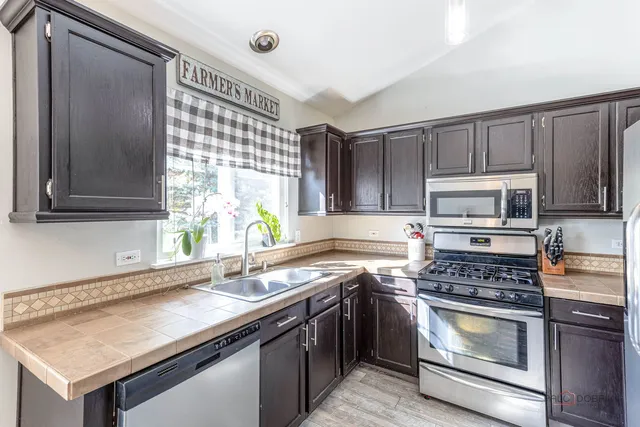 a kitchen with a sink stove and microwave