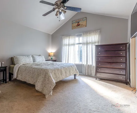 a spacious bedroom with a bed and a chandelier