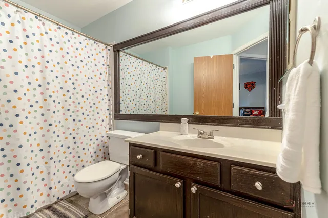 a bathroom with a sink toilet and mirror