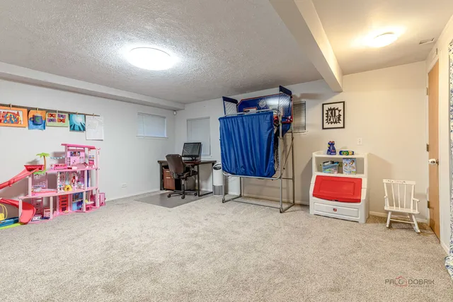 a view of livingroom with workspace and windows