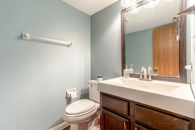 a bathroom with a sink a toilet and mirror